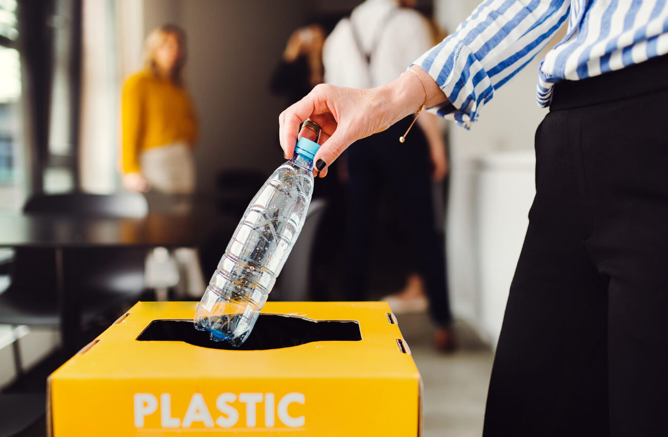 Employee recycling plastic
