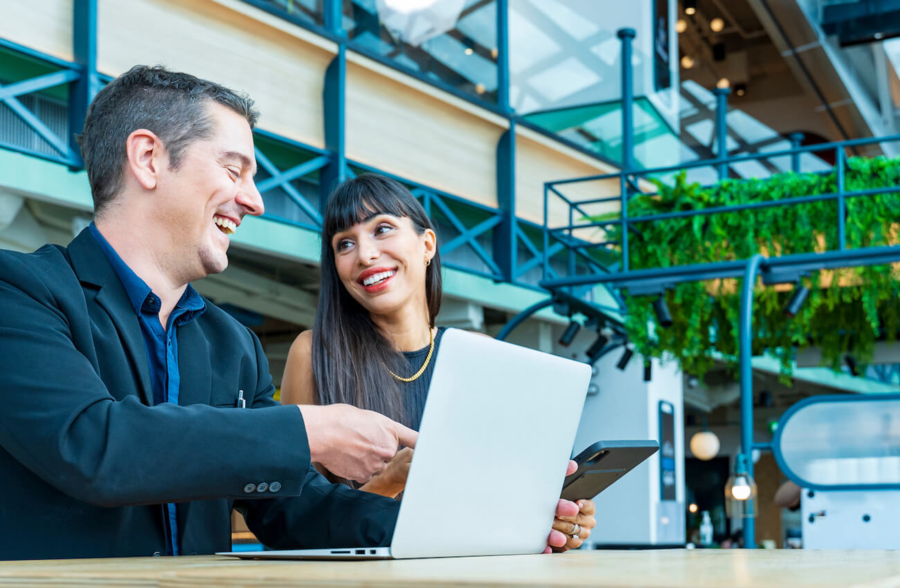 Sustainability at work with a man and woman looking at laptop
