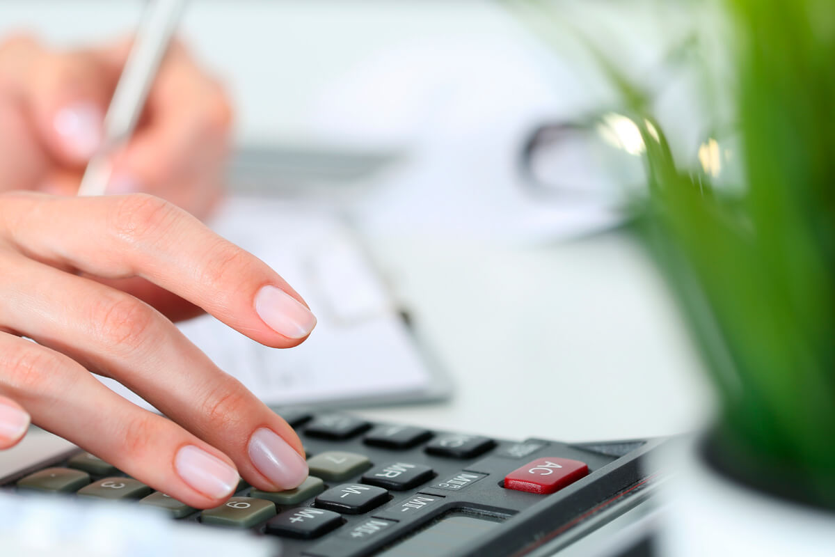 Woman working out costings with a calculator