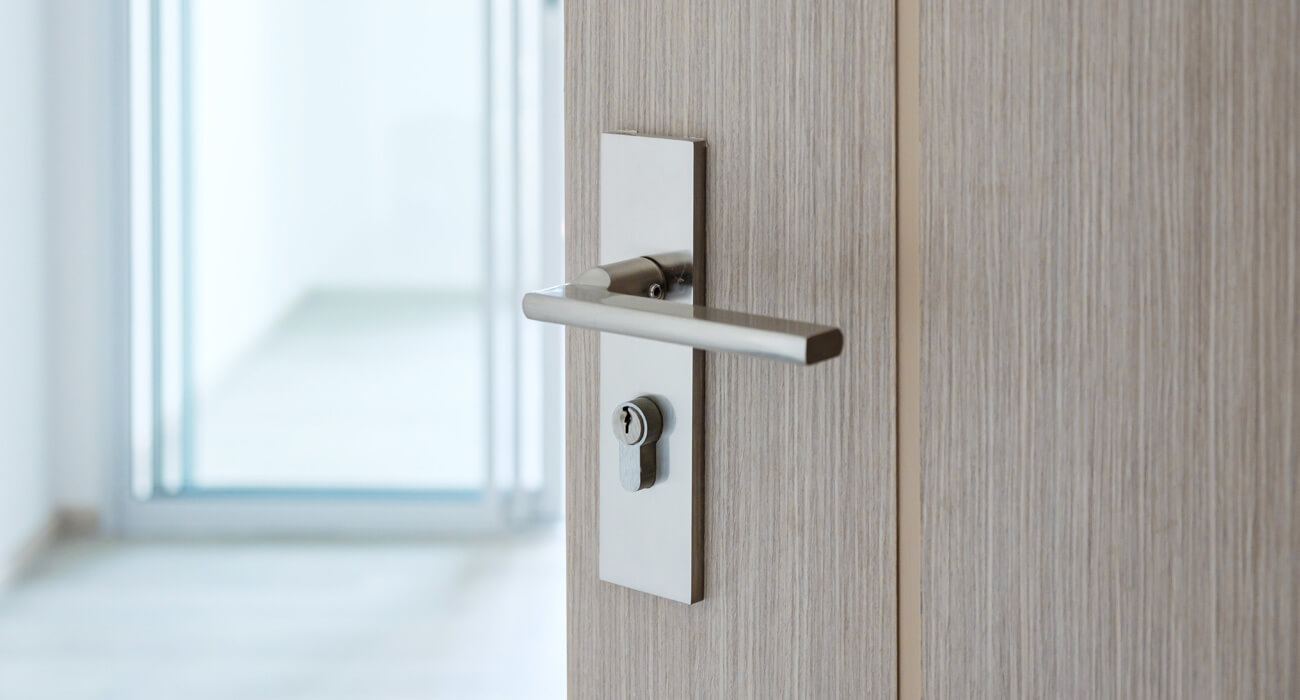 Open wooden door to bright room